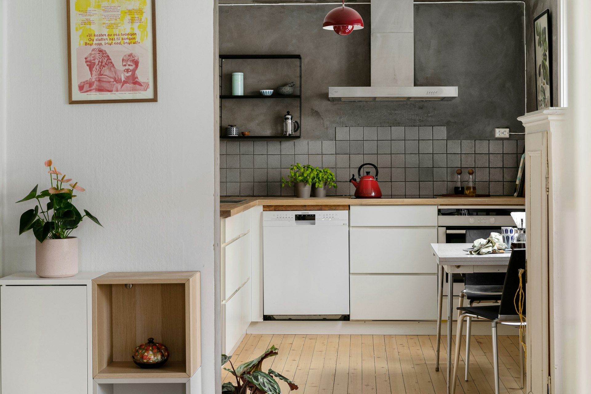 A kitchen with white cabinets and a wooden floor